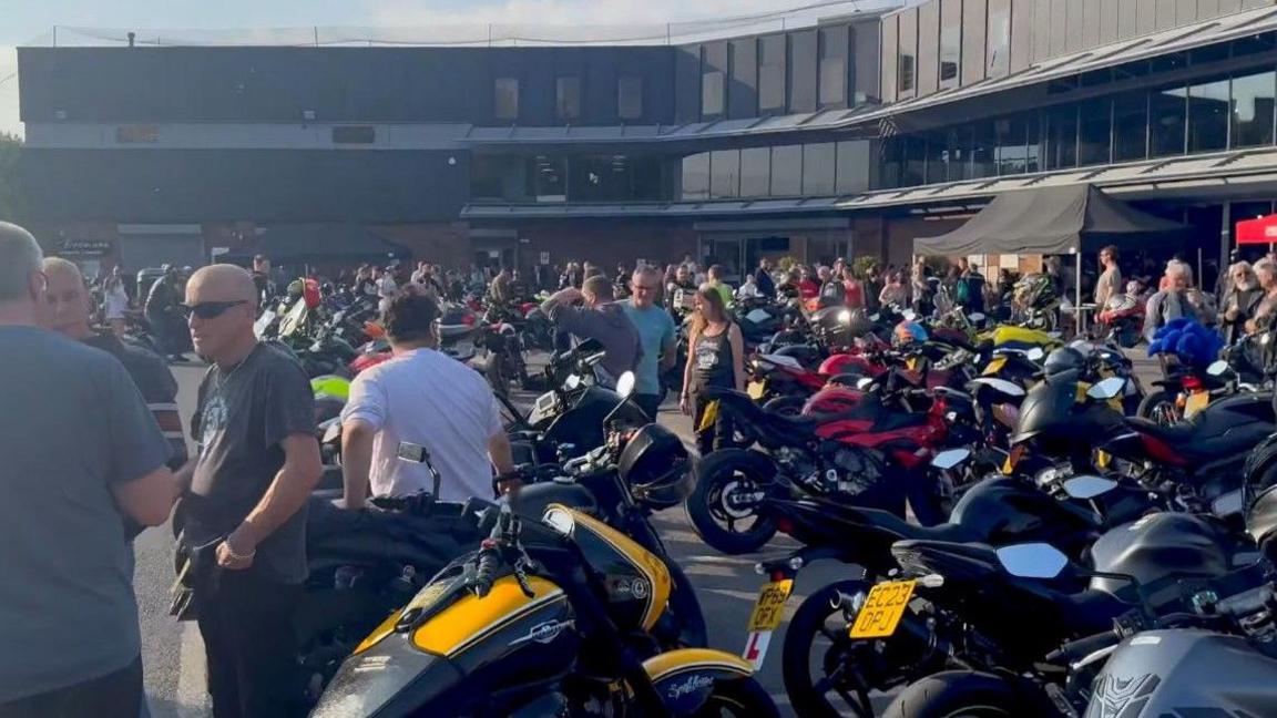 Lots of people are seen mingling among motorbikes parked at Fowlers of Bristol as part of Bike Night