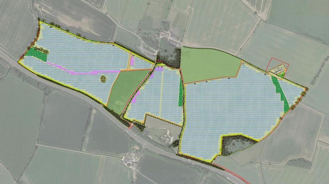 An aerial view of the site of the solar farm showing three adjacent fields outlined in yellow and A14 road alongside the southern edge.