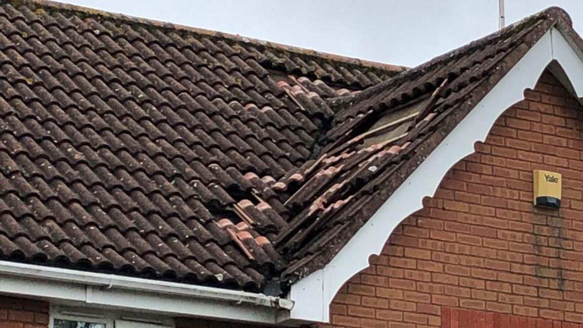 A close-up of roof damage caused by lightning