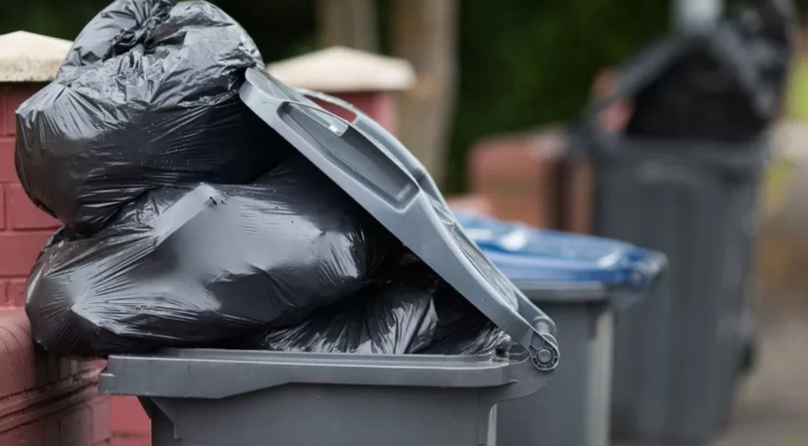 Black bags spilling out of bins