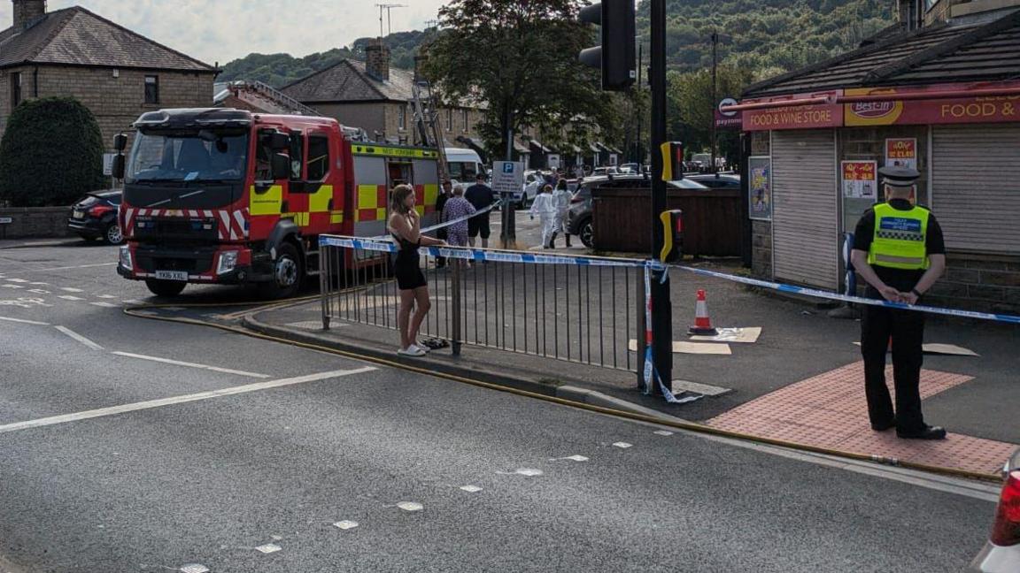 Fire engine and cordon at scene of house blaze