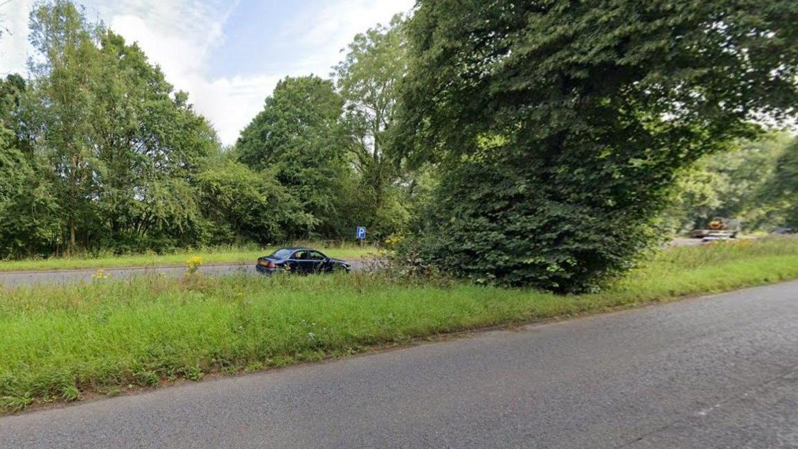 A generic image of the A456, which has two lanes in both directions at this point. Grass is in the centre of the road between the westbound and eastbound carriageway. A car is pictured in the centre of the photo.