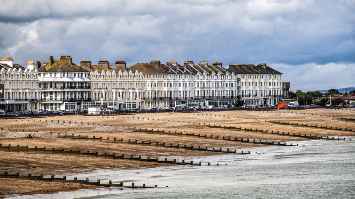 The beach at Eastbourne, showing groynes, the pebbles and seafront houses.