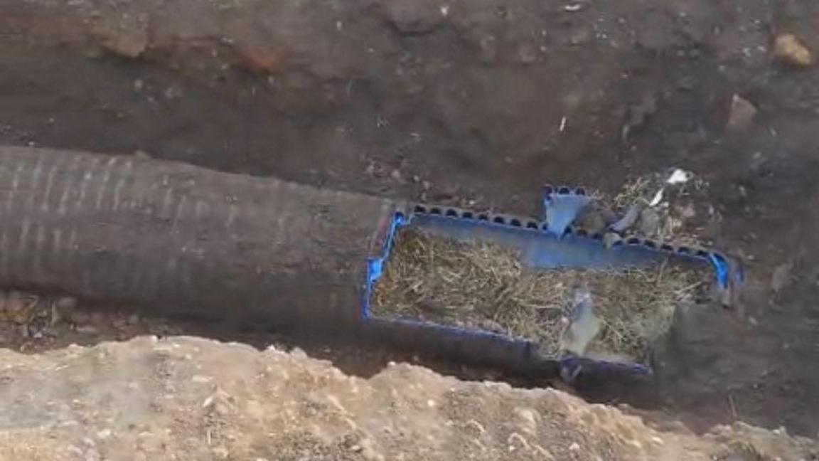 The underground pipe that the dog was rescued from. A section of the top of it has been cut away to rescue the dog.
