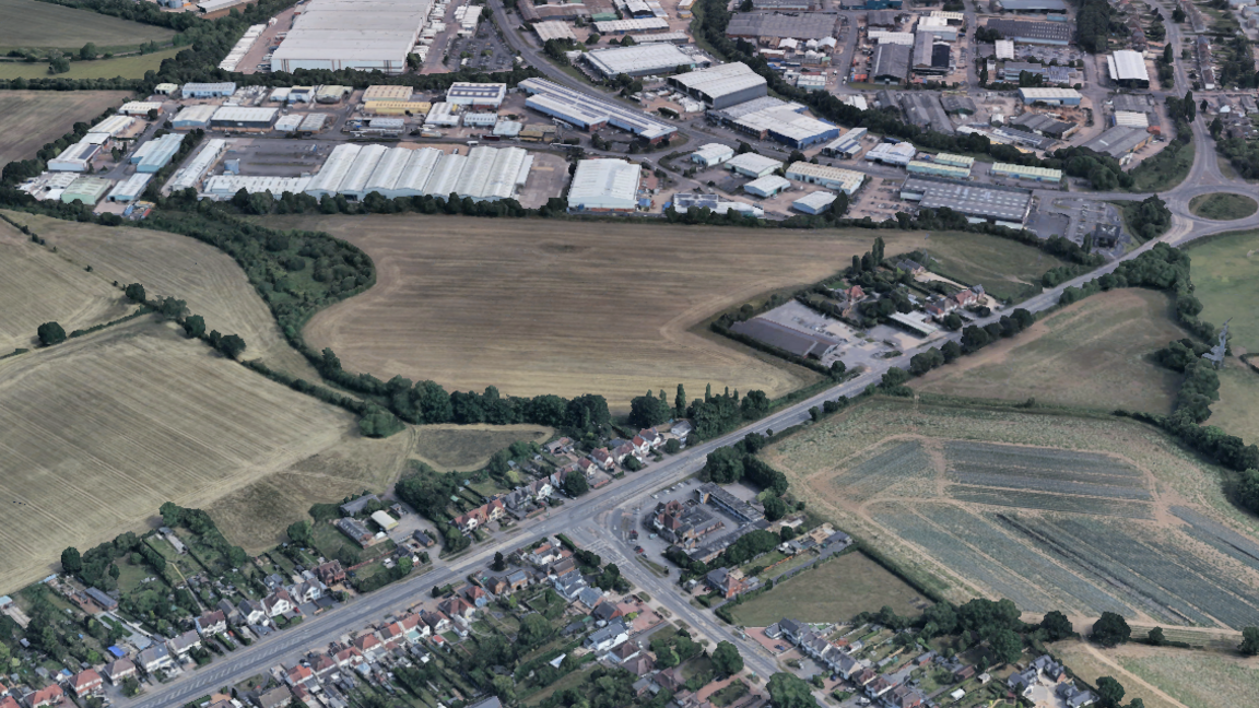 A satellite view of fields off the A5, on the outskirts of Hinckley, with an industrial estate at the top of the image and a housing estate at the bottom of the image.