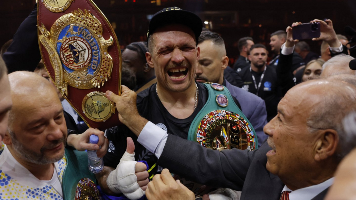 Oleksandr Usyk in tears as he is handed his belts