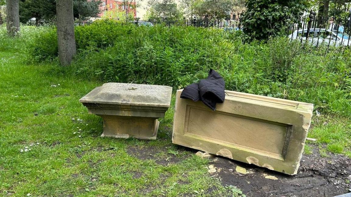 A stone pillar, which has been knocked to the ground in Leazes Park