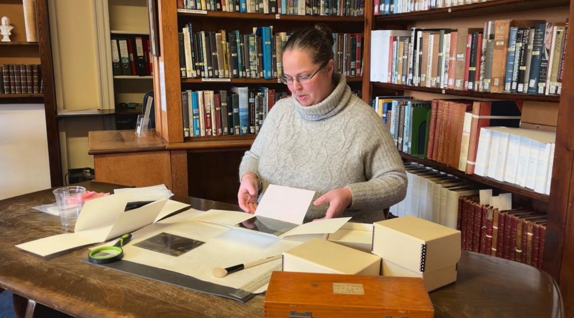 Kirstie Prevel opening a box of photographs