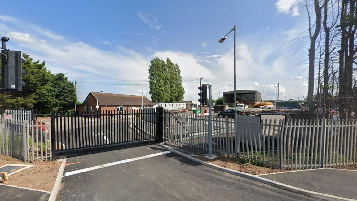 General view of Gamston Highways Depot. Iron gates and fencing can be seen from the road.