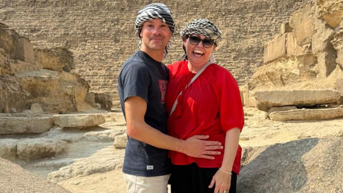 Matt and Gemma standing in front of the pyramids in Egypt