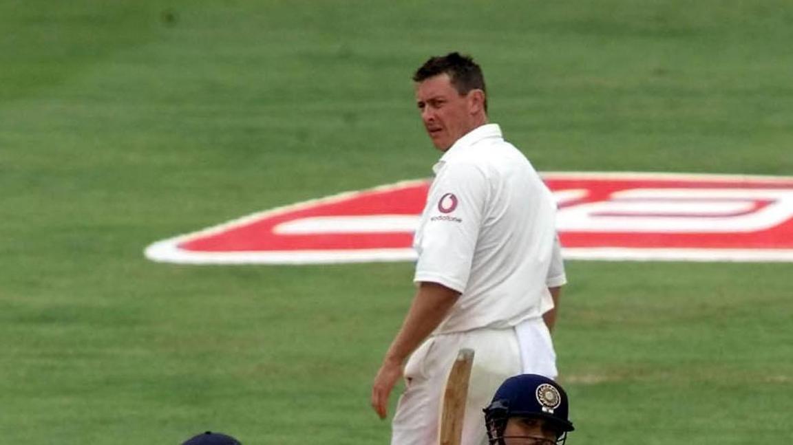 Ashley Giles playing for England in a test match against India at Headingley in 2002. He is walking away from the wicket but is turned to look back at the batsmen. He doesn't look happy and, given one of the opposition has his bat in the air, he might have just been pinged to the boundary.