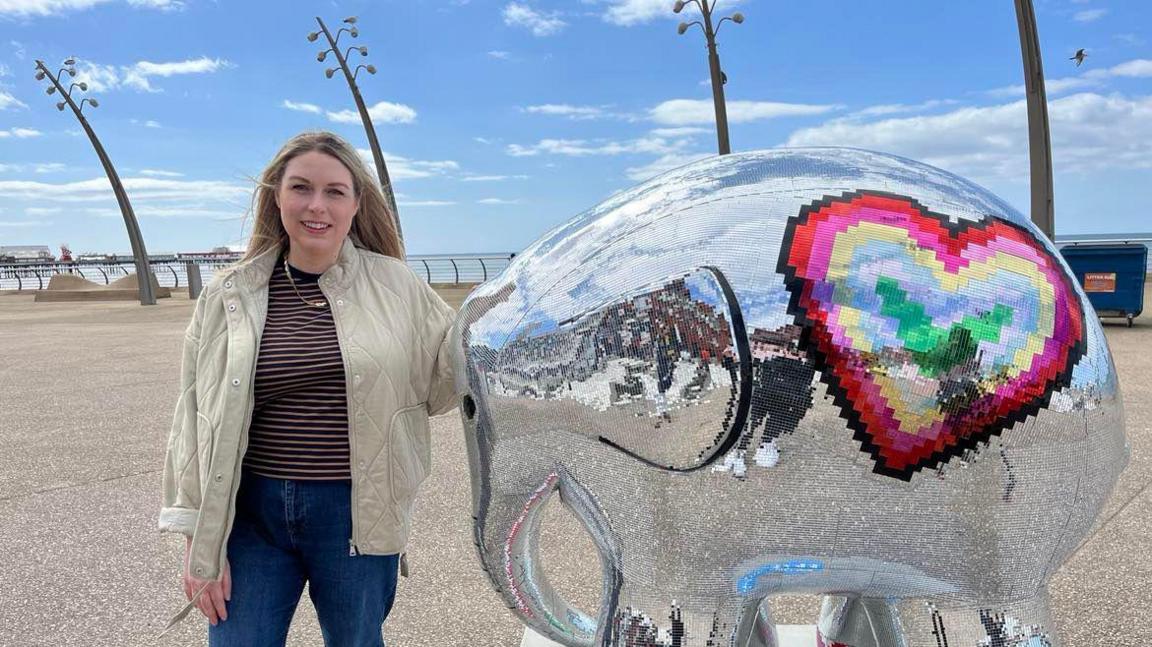 Artist Natalie Ratcliffe with her Elmer artwork