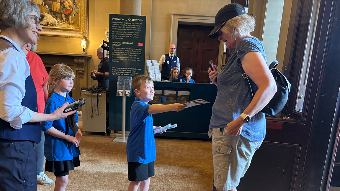 Pupil hands out leaflet.