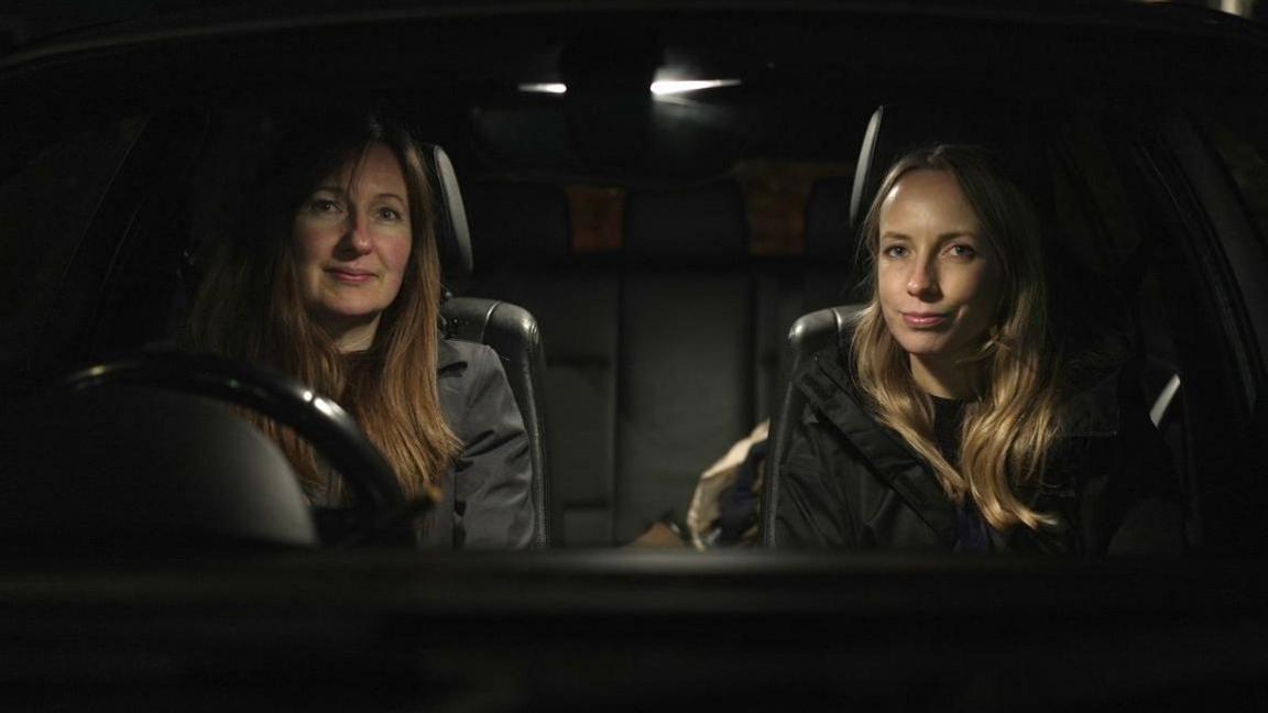 Rose Brown, an Avon and Somerset Police sex work liaison officer, sat in a car at night with Jo Ritchie, a Barnardo's social worker. They are looking direct into the camera.