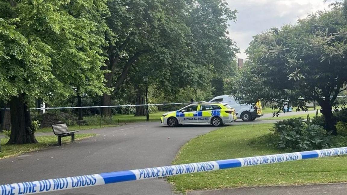 Police car guards a taped section of East Park