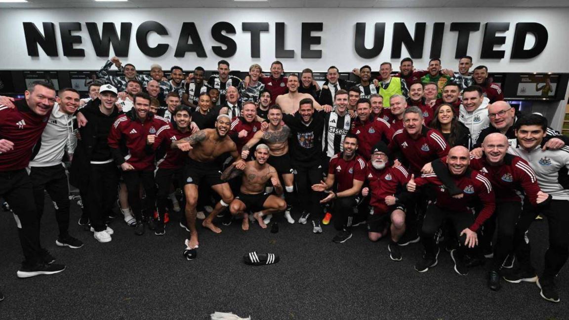 Newcastle players and coaching staff celebrate after a win in December 2024