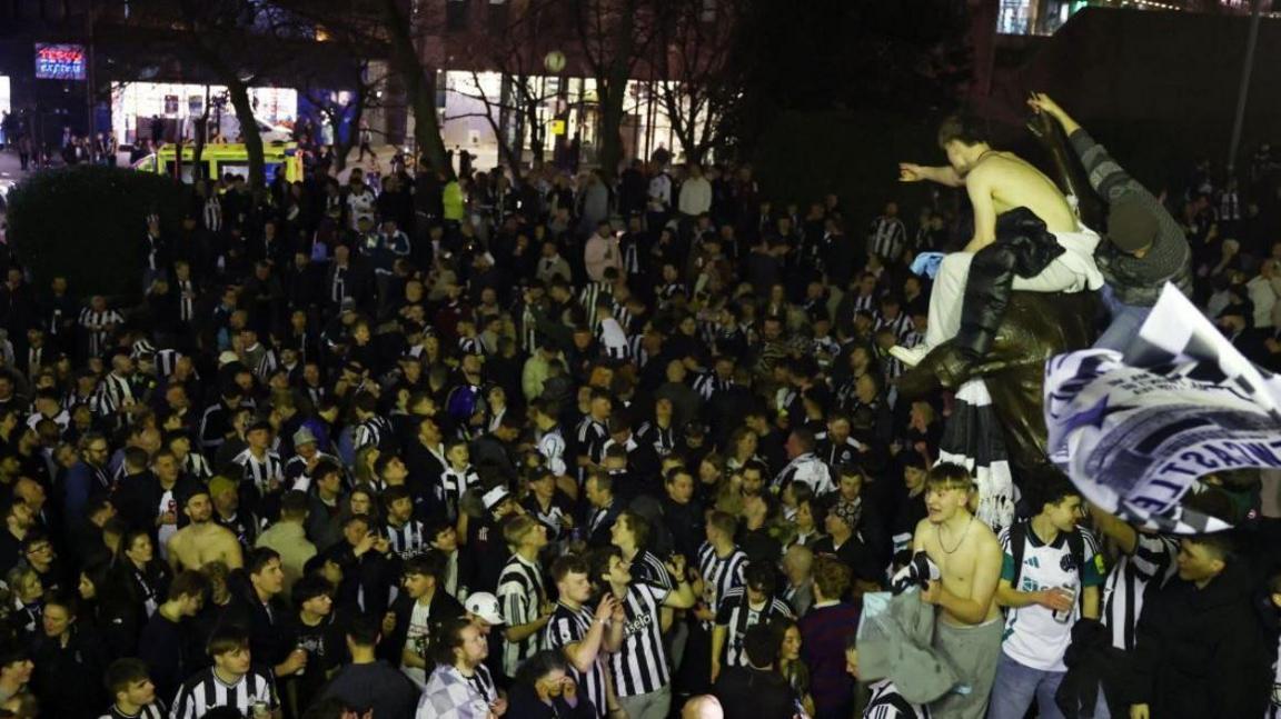 Newcastle United fans celebrate outside St James' Park after winning the Carabao Cup