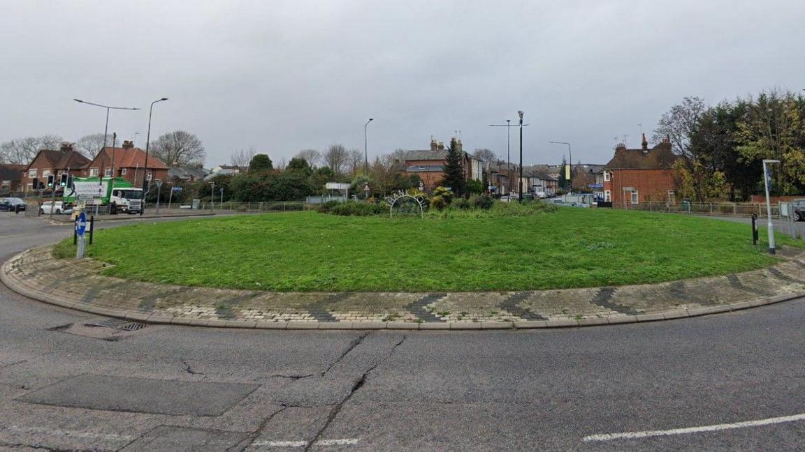 The Albert roundabout in Colchester is covered with grass and has a central metal sign saying Thank You NHS