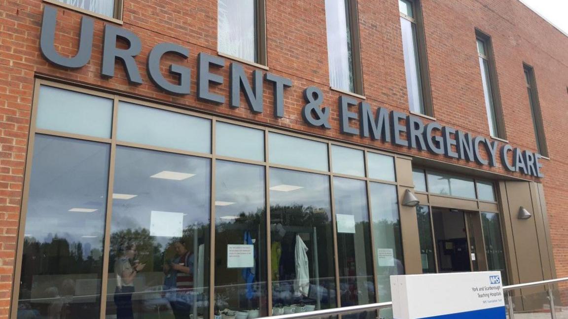 Scarborough Hospital's urgent and emergency care centre. A brick building with large windows. A large sign above the entrance says Urgent & Emergency Care.