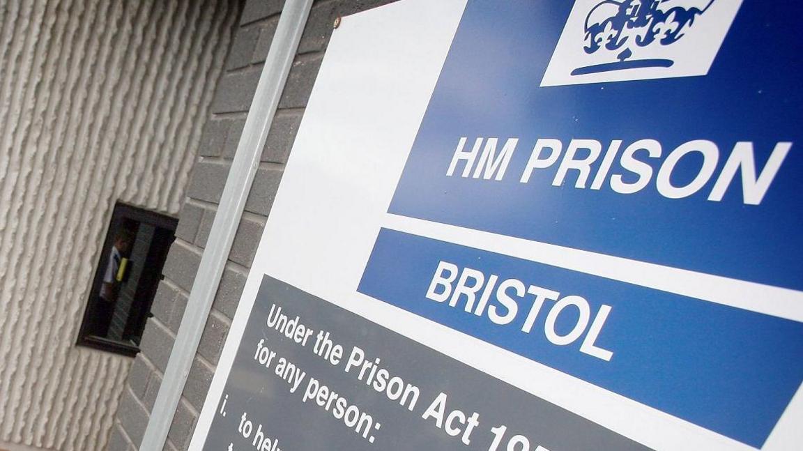 An HMP Bristol sign, with white writing on a blue background