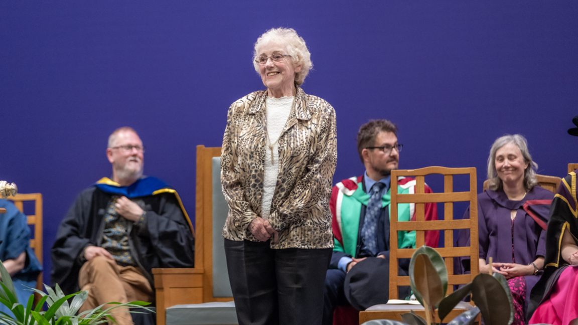 Sandra Freeman standing on a stage at a graduation ceremony