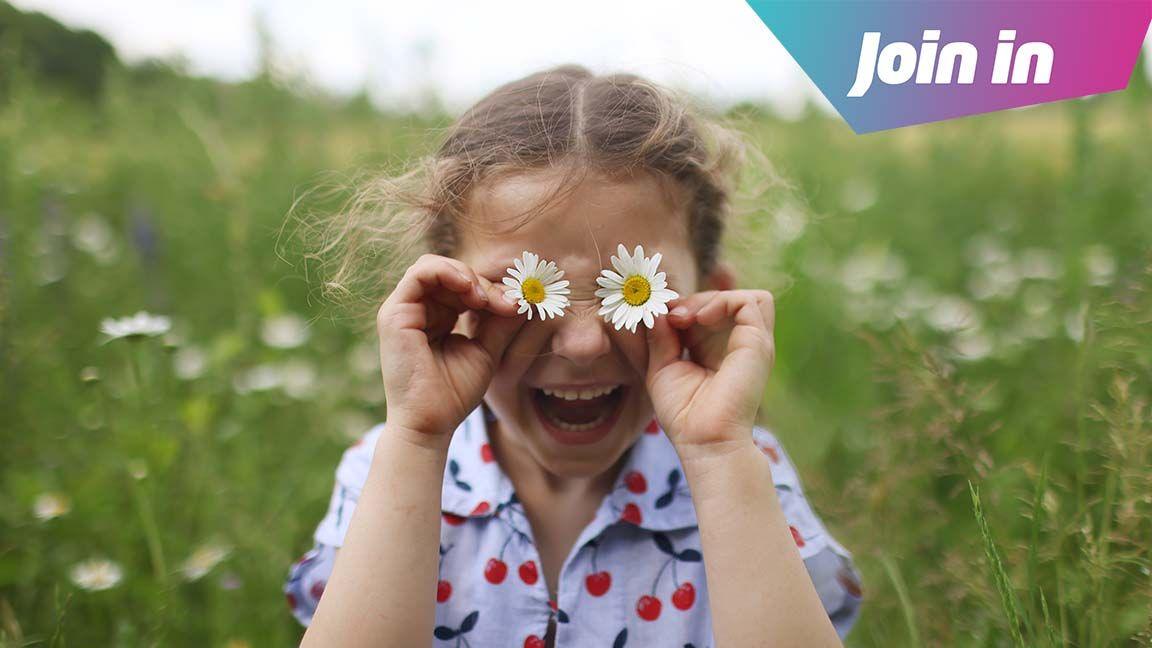 Girl playing with daisys
