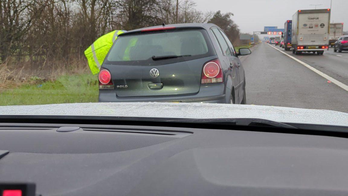 A car stopped by police on the M1 northbound between junctions 9 and 10 