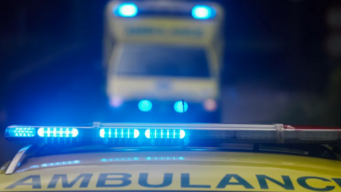 The top of an ambulance with it's blue lights on.