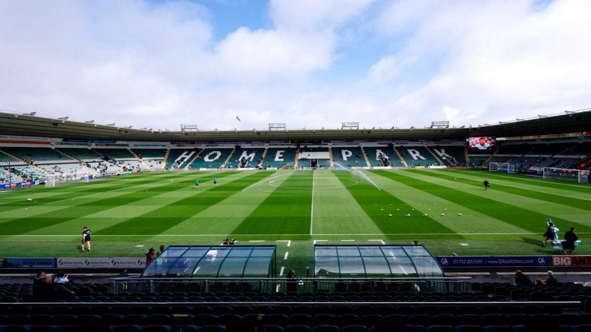 A picture taken from the side of home park stadium. It is a large stadium with grass in the middle