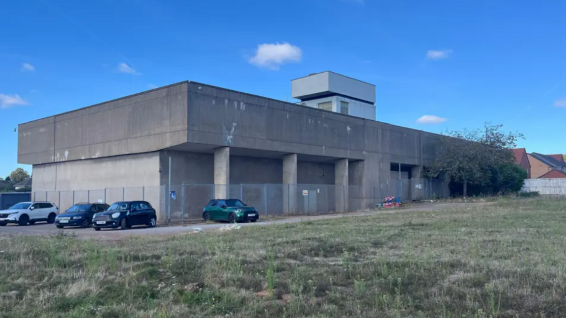 Concrete war room building with cars outside the building