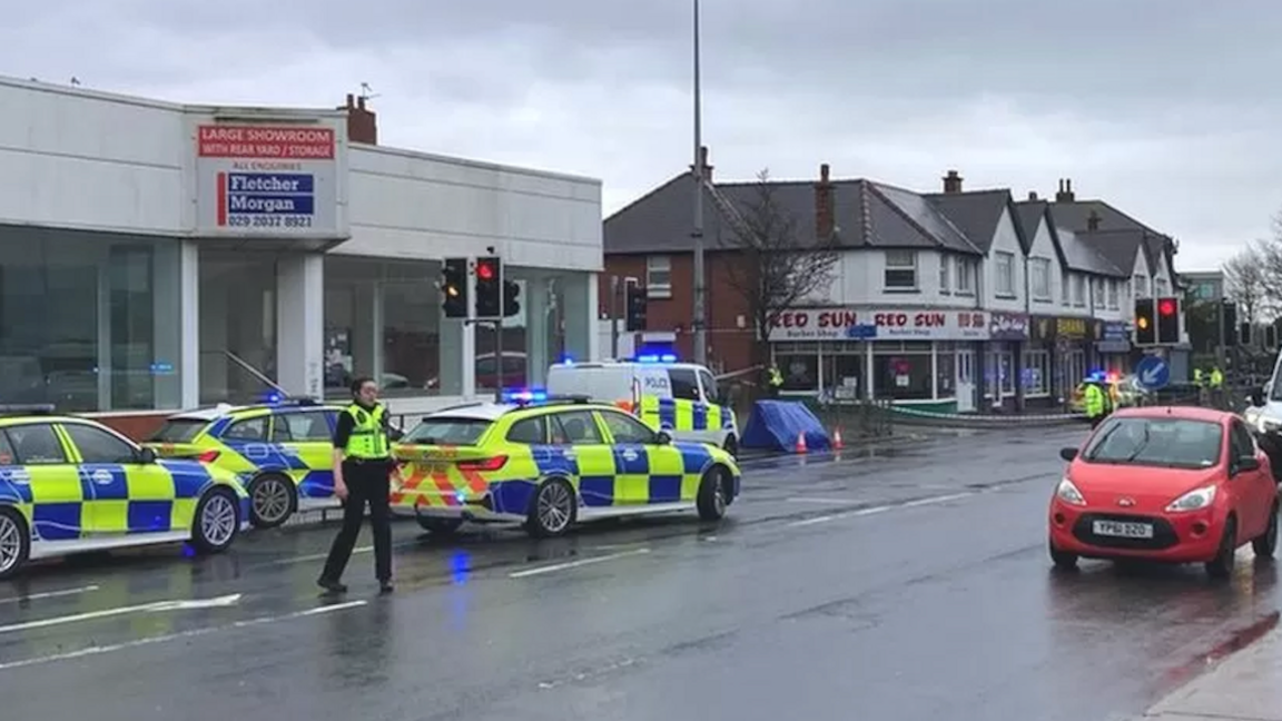 Police cars at the scene of the murder 