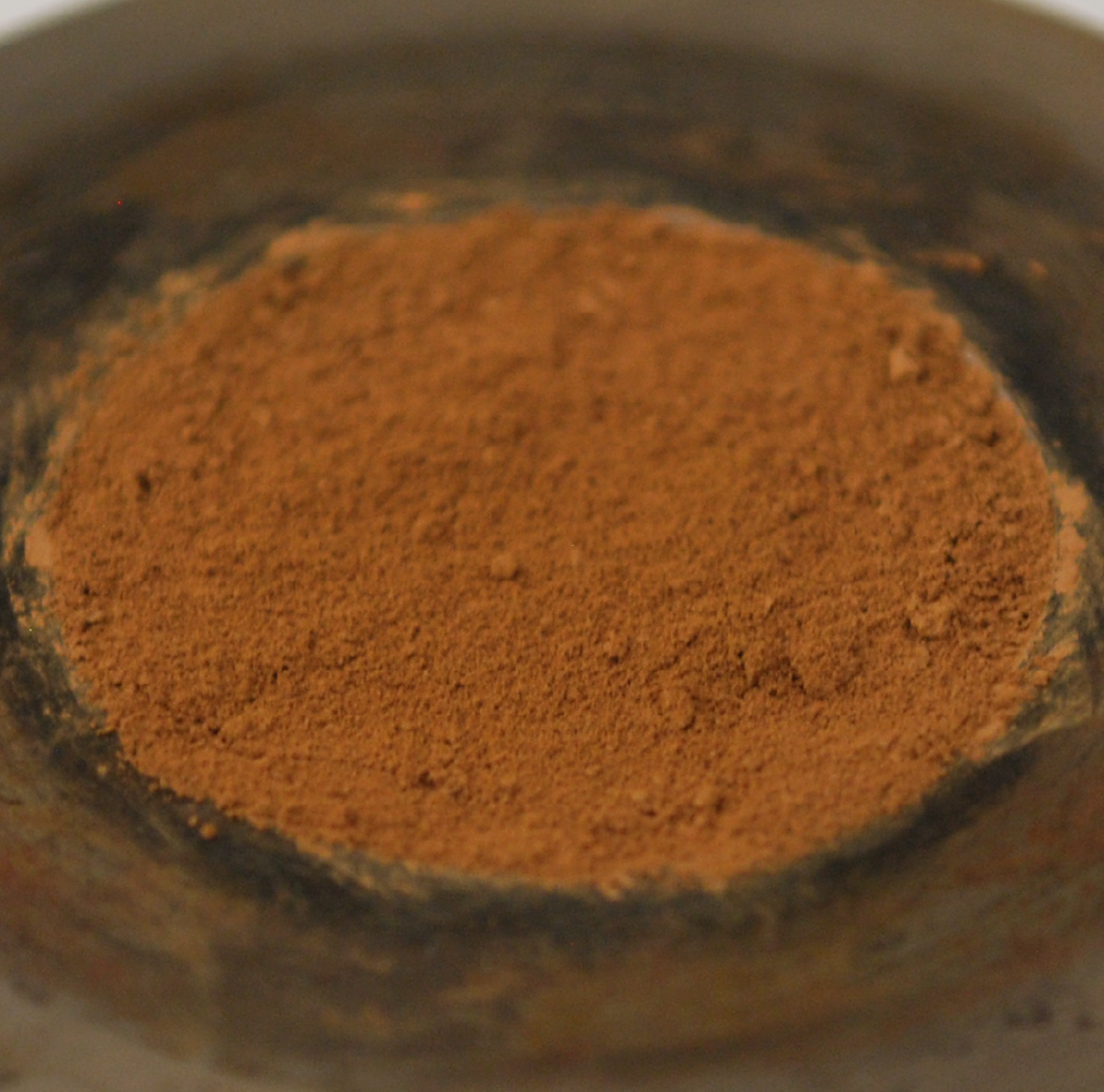 A disc of orange-terracotta coloured dust. 