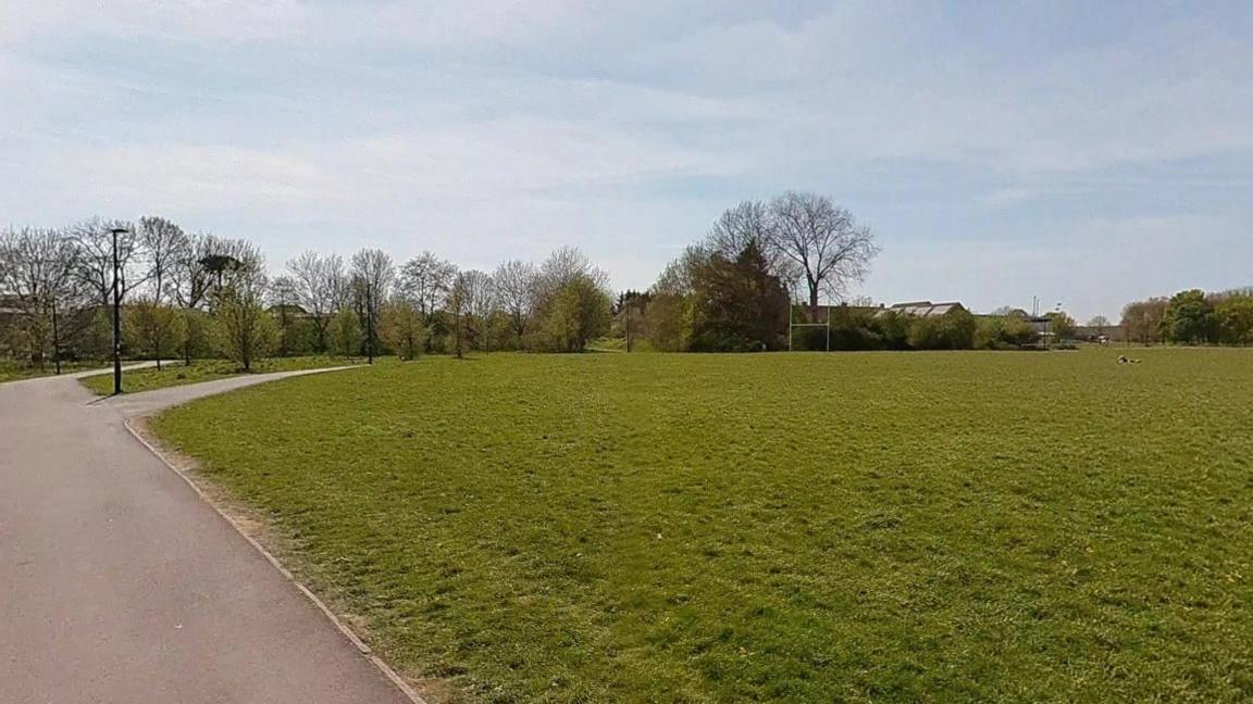 Rugby posts can be seen in the distance inside a seemingly empty park in Fishponds in Bristol, on a dry winter's day.