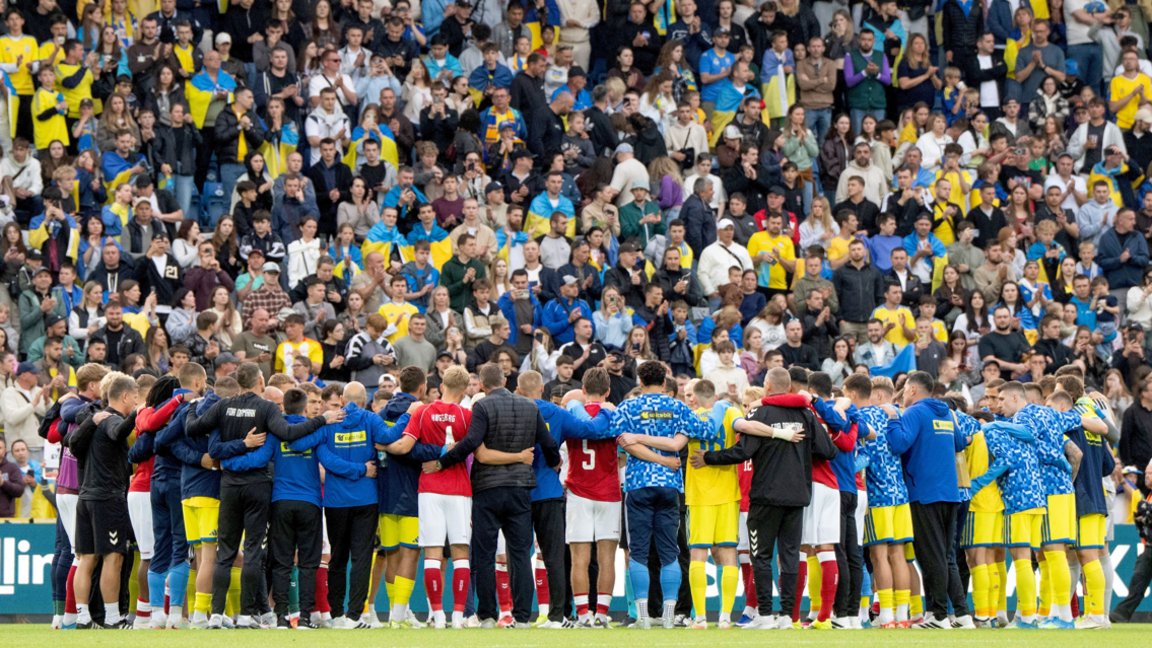 Denmark and Ukraine players in a huddle after their friendly in June 2026 is abandoned