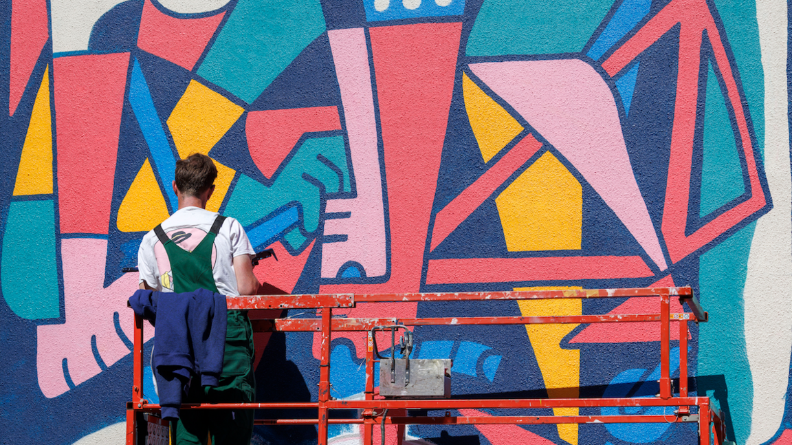 Street artist painting a mural