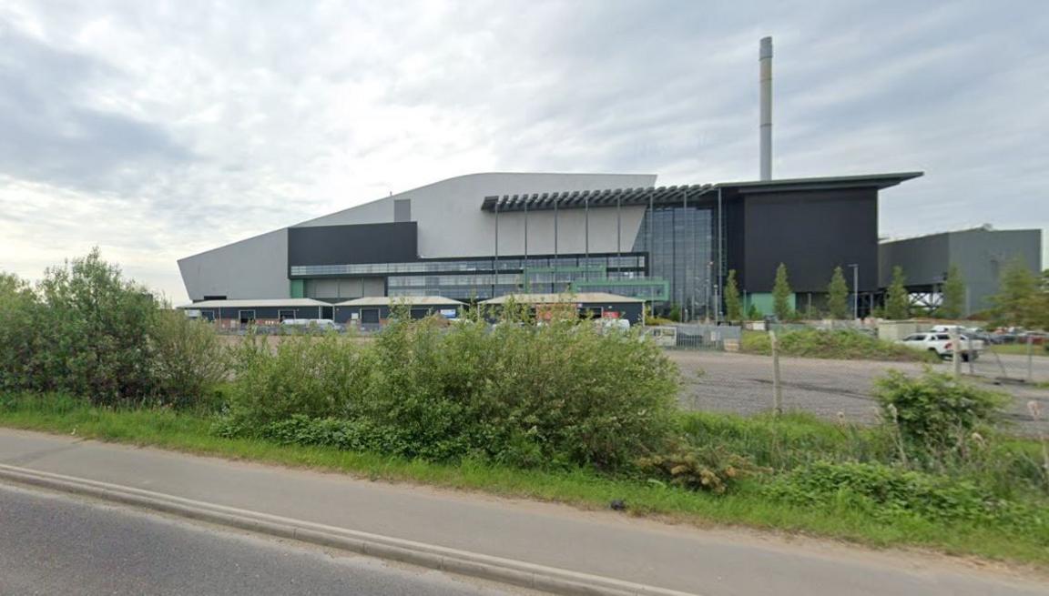 Google image of the incinerator plant in North Hykeham. It is a modern looking glass-fronted building with a sloping roof, with a chimney visible towards the rear.