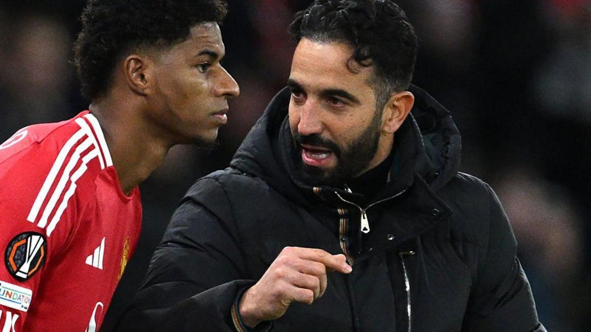 Marcus Rashford taking instructions from Manchester United manager Ruben Amorim before being introduced into a game as a substitute