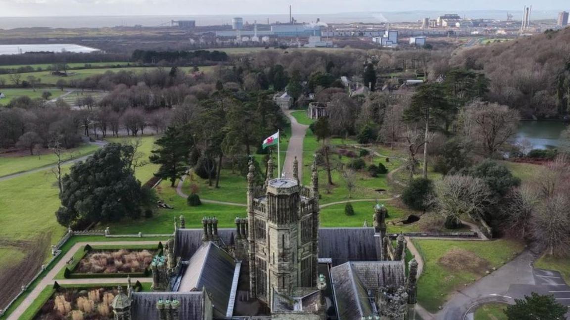 An aerial photo with Margam Castle in the foreground and the Port Talbot steelworks in the distance.