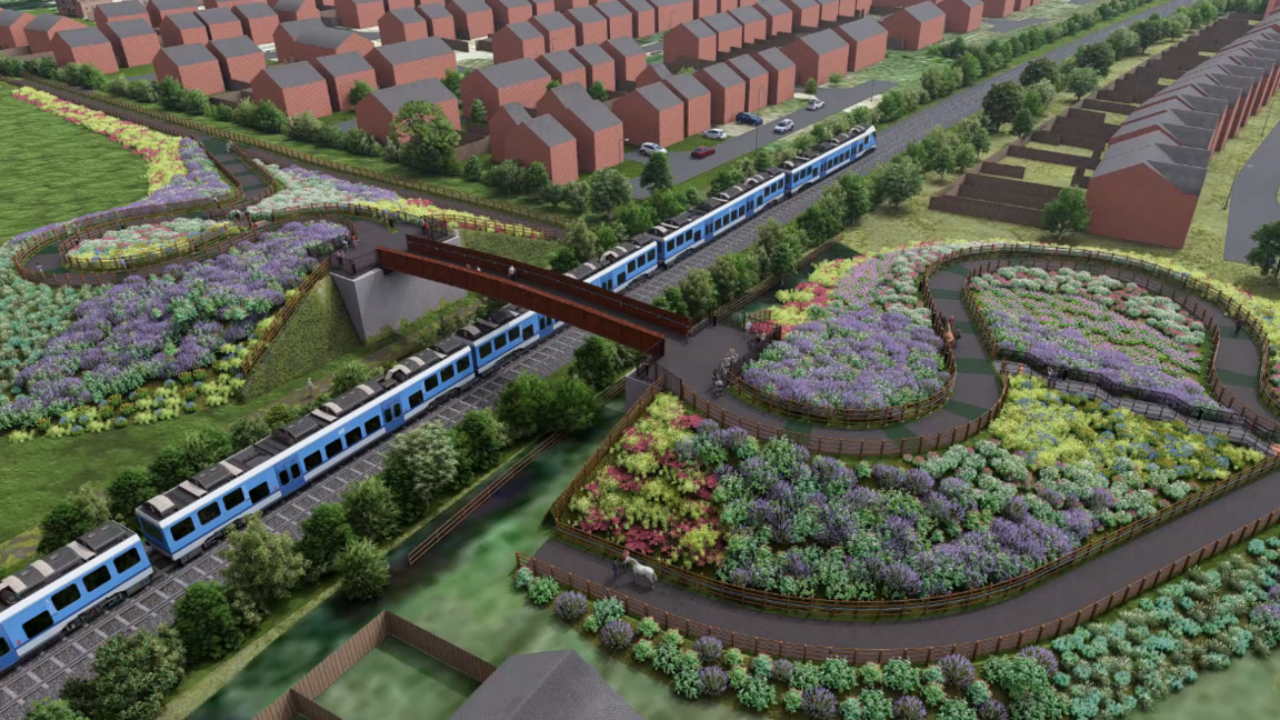 An aerial view of the proposed bridge at Woodmansey. A blue train is travelling under it and people are walking along a path surrounded by flowers.