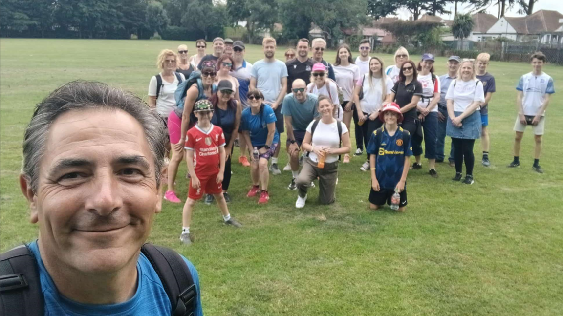 A selfie showing Mr Lansley smiling with a group of people who have joined him in the background