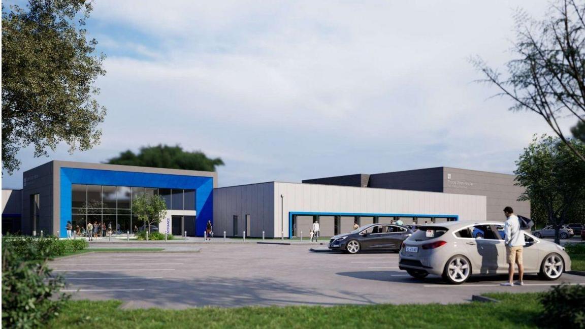 An artist's impression of the new facility. Three single-storey buildings stand in front of a car park. The first is glass-fronted with a blue border. The other two are grey blocks.
