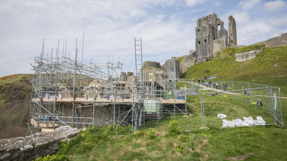 Corfe Castle with scaffolding around a tower.
