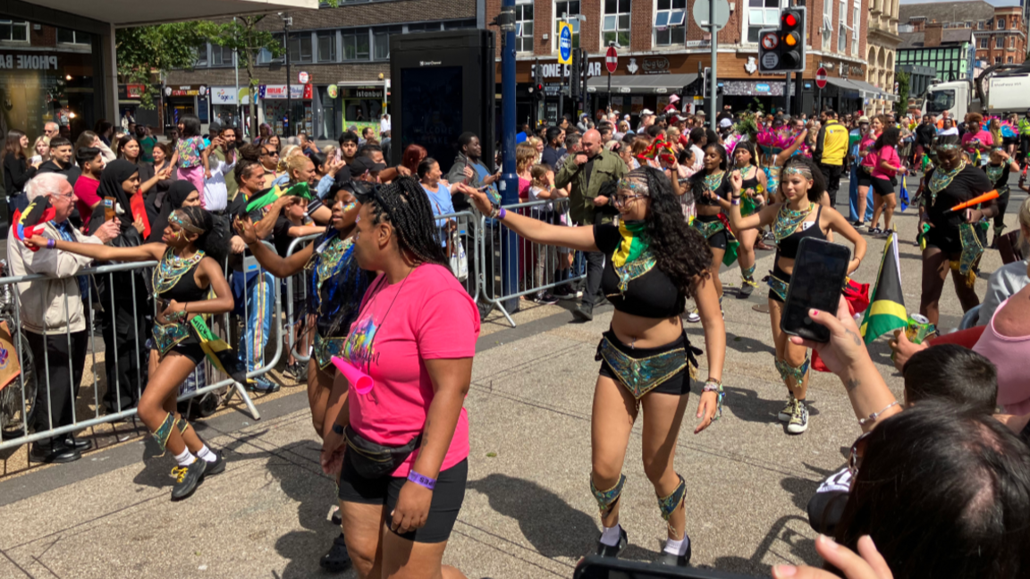 Dancers parade through Leicester with crowds lining the streets for the city's 40th Caribbean Carnival in 2025.