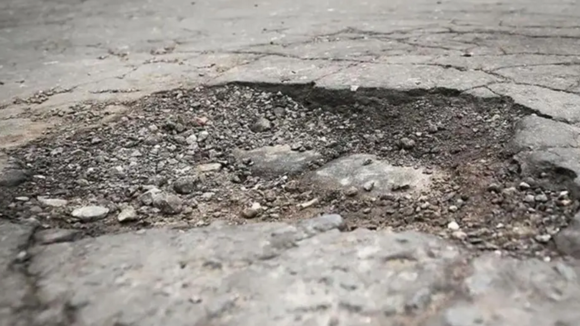 A large pothole in concrete