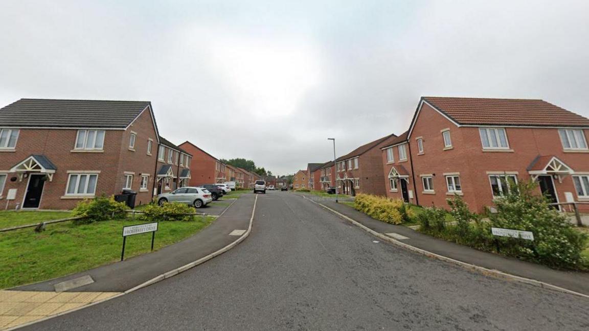 Streetview of Frosterley Drive. It is a street of two-storey houses, mixture of detached and semi-detached, made from red brick.