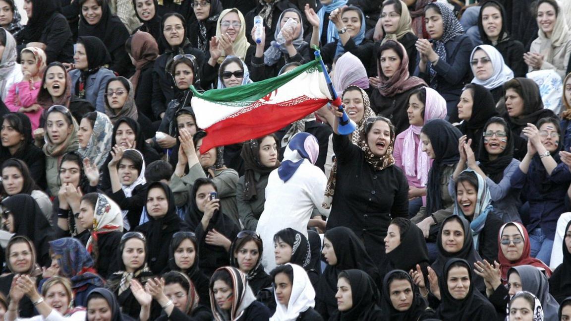 Women cheer at a friendly football match in Tehran in 2006