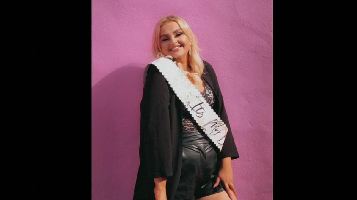 A young woman wearing a sash