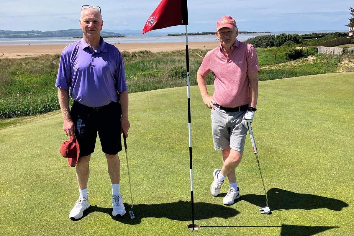 Rob Davis and David Lewis pose next to their hole in one 