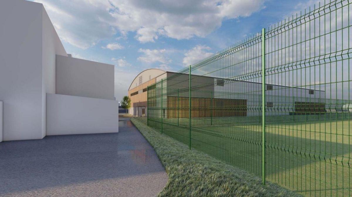 A digital rendering of what the Oakfield facility could look like shows a 3G football pitch surrounded by a green metal fence. In the distance is a large sports hall which has wooden panels on it.