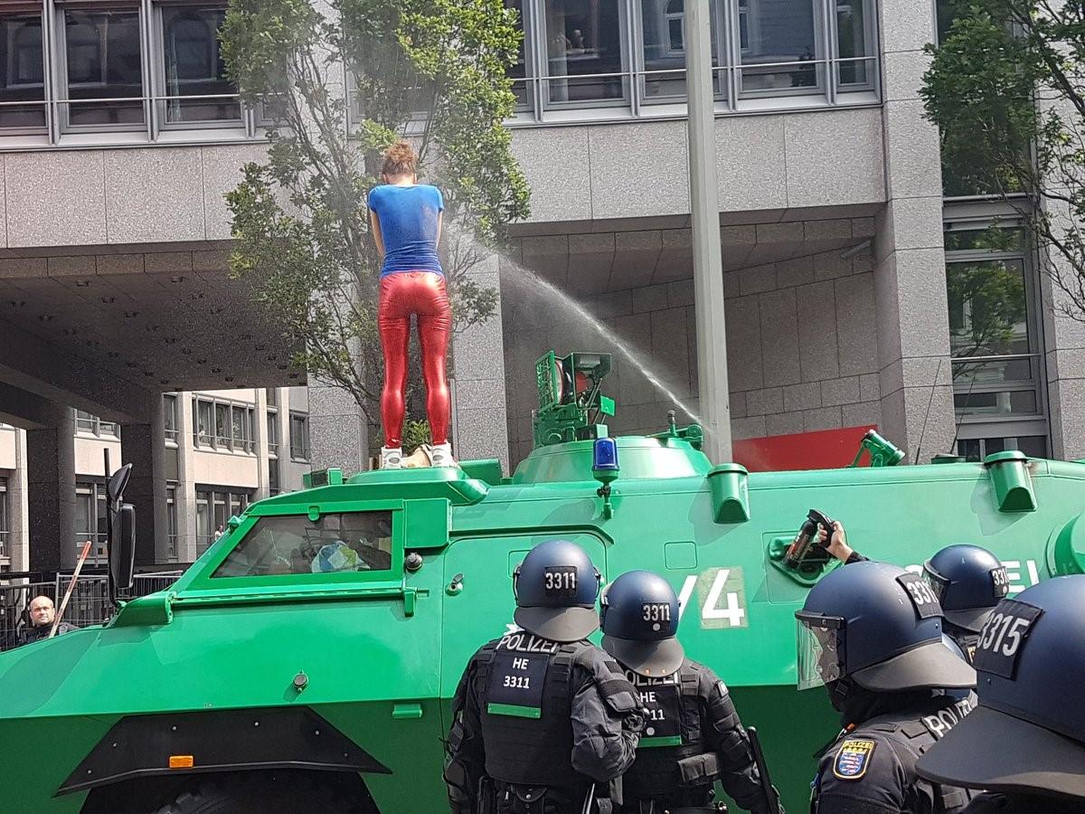 Police use spray against a protester standing on an armoured car in Hamburg, 7 July